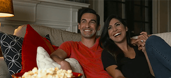 couple enjoying a movie and popcorn in spotlight video for Protect Every Moment