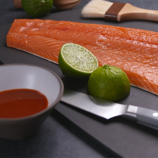 food photography raw salmon and limes on cutting board